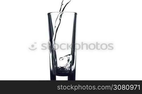 Filling a glass of color liquid on white background.