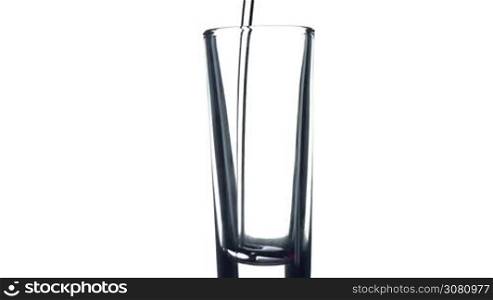 Filling a glass of water on white background. Healthy and fresh water