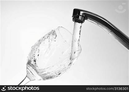 Filling glass with fresh water from faucet