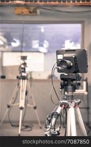 Film camera on a tripod in a television broadcasting studio