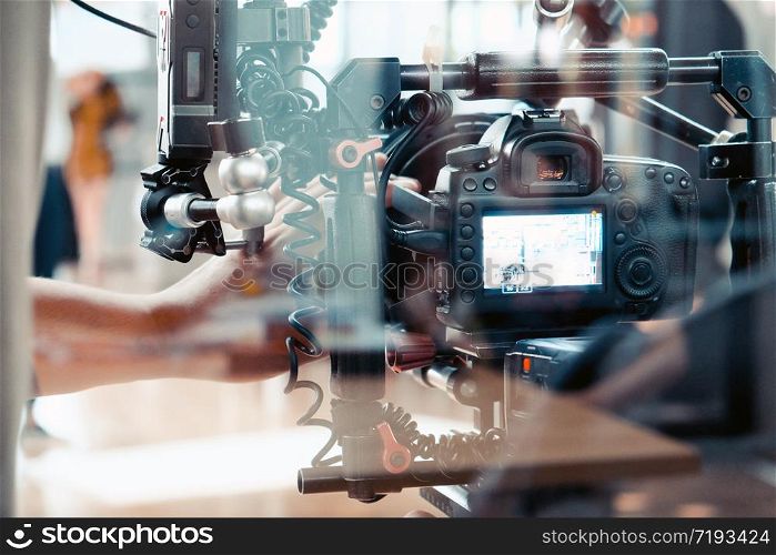 Film crew, cameraman shooting film scene with camera
