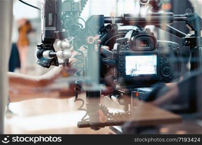 Film crew, cameraman shooting film scene with camera