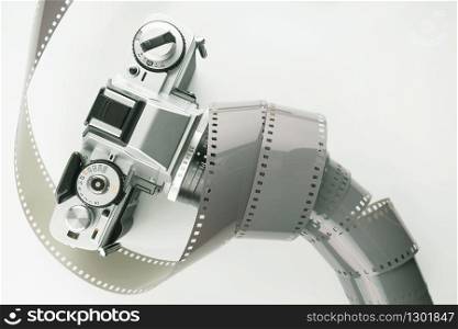 Film slr camera and a roll of 35mm negative film. Film camera and negative film.