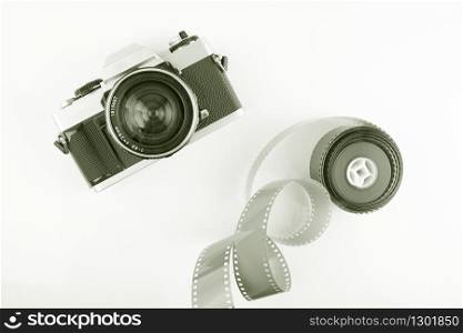 Film slr camera and a roll of 35mm negative film. Film camera and negative film.