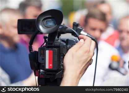 Filming an media event with a video camera