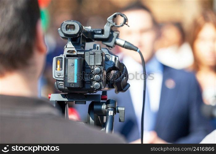 Filming media event or news conference with a video camera