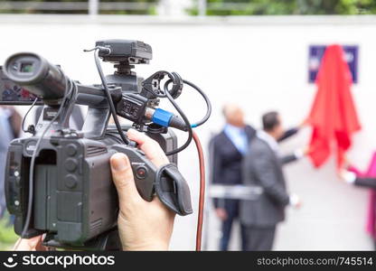 Filming media event with a video camera