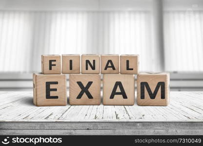 Final exam sign in a bright education room on a wooden table