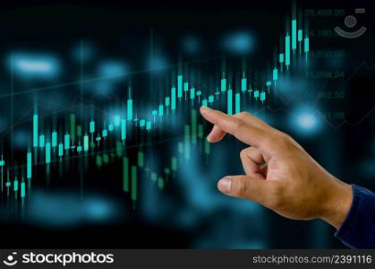 Finance and business investment concept. Stock and crypto investment funds.Businessman touching virtual screen data candlestick chart trading Forex graphs of financial.