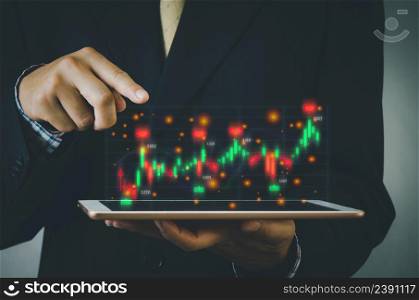 Finance and business investment concept. Stock and crypto investment funds.Businessman analyzing or trading Forex graphs of financial data candlestick chart.