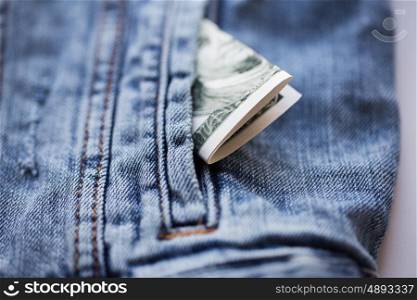 finance and currency concept - dollar money in pocket of denim jacket. dollar money in pocket of denim jacket