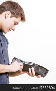 Finance and economy. Young man with wallet paying by credit card spending money. Buy and retail sell. Isolated on white. Studio shot.