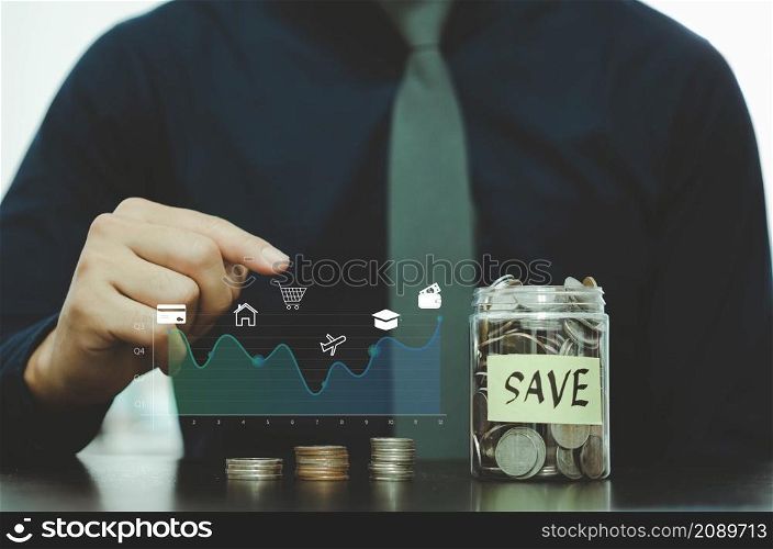 Finance and investment business. businessman virtual screen, graph and coin finance icons placed on the table.
