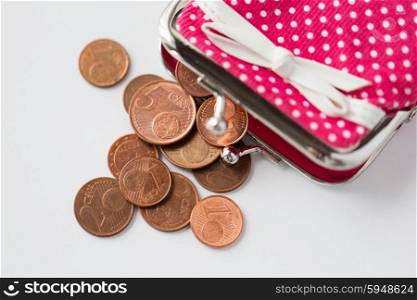 finance, cash, money saving and investment concept - close up of euro coins and wallet on table