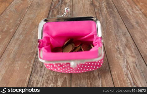 finance, cash, money saving and investment concept - close up of euro coins in wallet on table over wooden table background