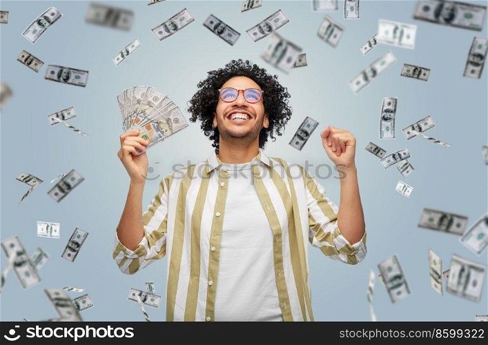 finance, currency and people concept - happy man holding hundreds of dollar money banknotes celebrating success over grey background. happy man with dollar money celebrating success