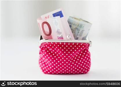 finance, investment, saving and cash concept - close up of euro paper money in pink wallet