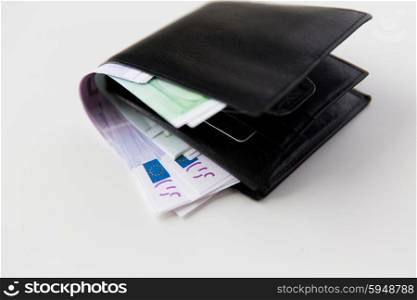 finance, investment, saving and cash concept - close up of euro paper money in wallet