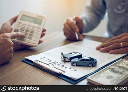 Finance manager of the car showroom is calculating the cost of reserving a new car for the customer while signing a car purchase contract.