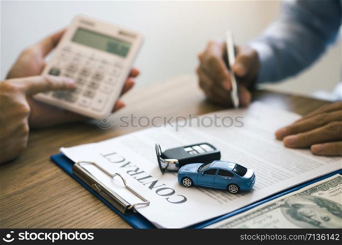 Finance manager of the car showroom is calculating the cost of reserving a new car for the customer while signing a car purchase contract.
