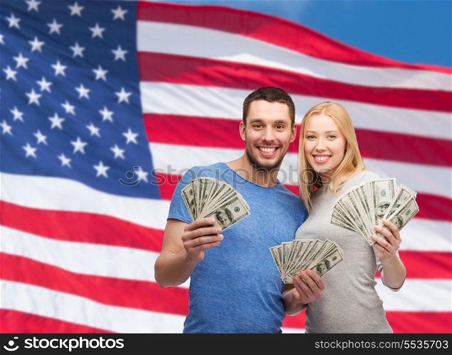 finance, money and family concept - smiling couple holding dollar cash money