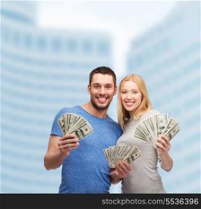 finance, money and family concept - smiling couple holding dollar cash money