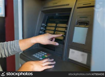 finance, money, bank and people concept - close up of hands choosing option on atm machine