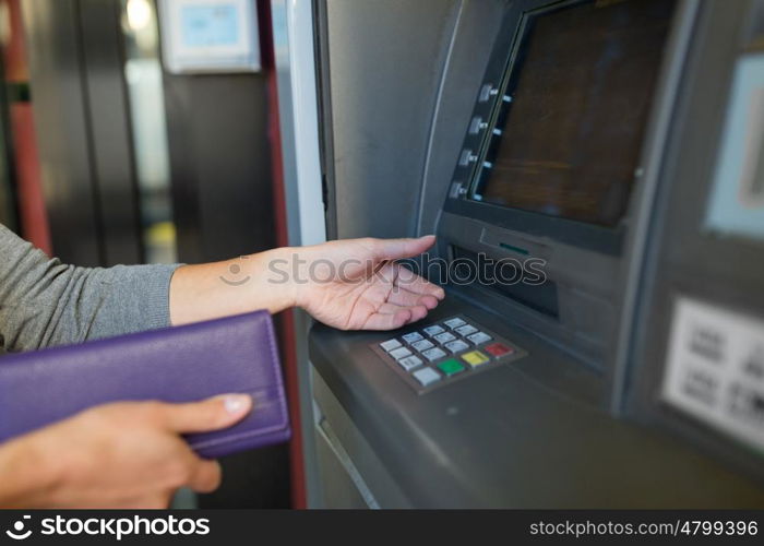 finance, money, bank and people concept - close up of hands with wallet withdrawing cash at atm machine