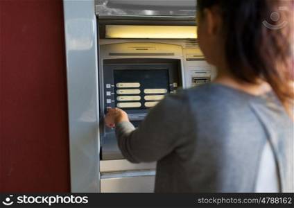 finance, money, bank and people concept - close up of woman choosing option on atm machine
