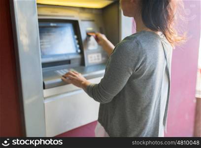 finance, money, bank and people concept - close up of woman inserting card to atm machine