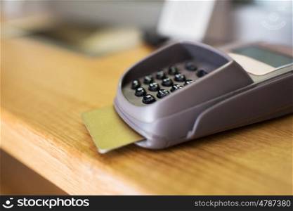 finance, money, technology, payment and people concept - close up of bank card reader or atm terminal