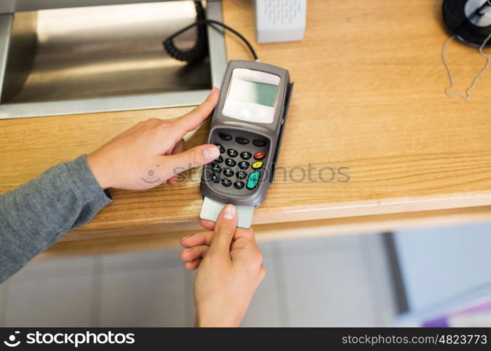 finance, money, technology, payment and people concept - close up of hand inserting bank card to terminal