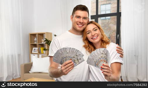 finance, saving and people concept - portrait of happy couple in white t-shirts with euro money over home background. happy couple in white t-shirts with dollar money