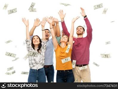 finance, wealth and people concept - group of happy friends picking money falling from up above over white background. happy friends picking money falling from up above