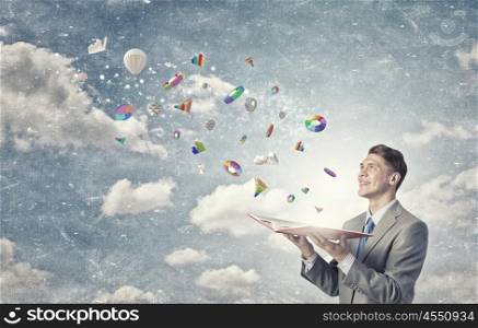 Finances and economics. Young businessman with opened book in hands and icons flying out