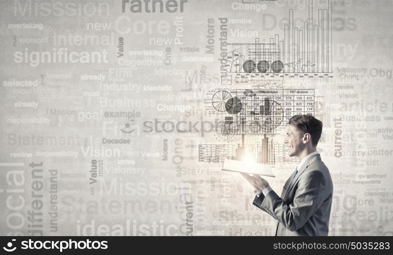 Finances and economics. Young shocked businessman with opened book in hands