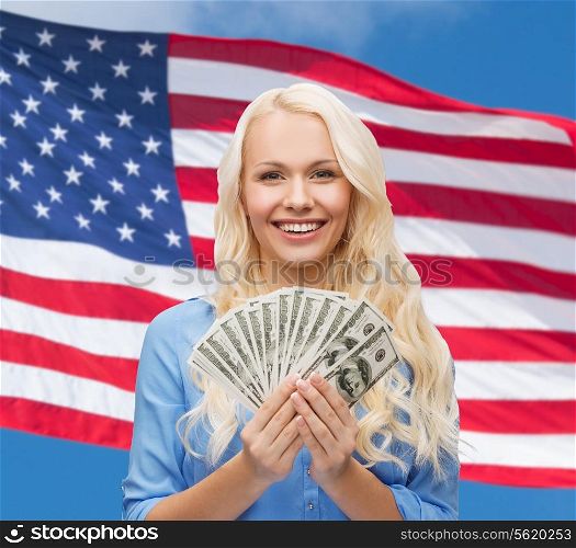 finances and people concept - smiling woman in red dress with us dollar money over american flag background
