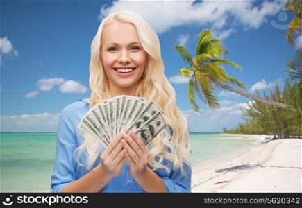 finances and people concept - smiling woman in red dress with us dollar money over tropical beach background