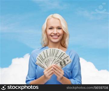 finances and people concept - smiling woman in red dress with us dollar money over blue sky with white cloud background