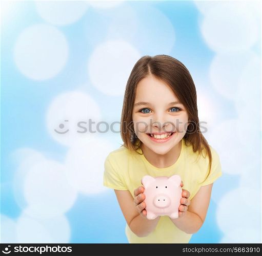finances, childhood, saving and people concept - beautiful little girl with piggy bank