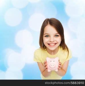 finances, childhood, saving and people concept - beautiful little girl with piggy bank