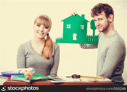 Finances property ownership real estate documents paperwork concept. Smiling couple preparing their future. Young girl and boy planning house for family.. Smiling couple preparing their future.