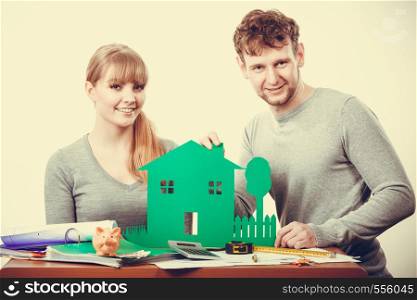 Finances property ownership real estate documents paperwork concept. Smiling couple preparing their future. Young girl and boy planning house for family.. Smiling couple preparing their future.