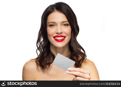 finances, shopping and people concept - happy smiling young woman with red lipstick holding credit card over white background. beautiful woman with red lipstick and credit card