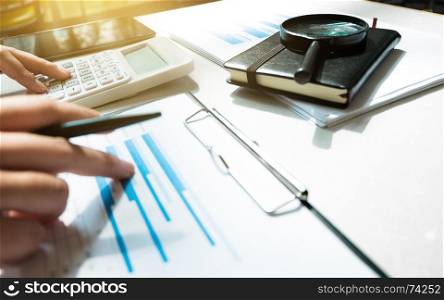 Financial accounting Business woman using calculator while pointing on data documents