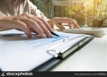Financial accounting Business woman using calculator while working