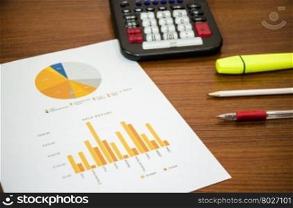 Financial accounting graphs analysis with pen and calculator