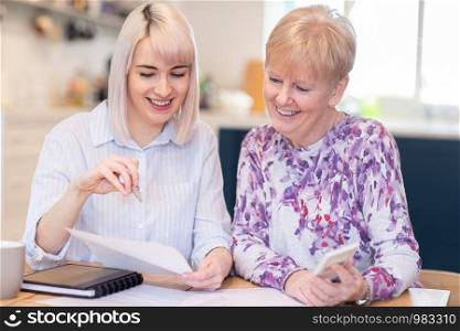 Financial Advisor Helping Senior Neighbor With Paperwork