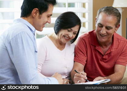 Financial Advisor Talking To Senior Couple At Home