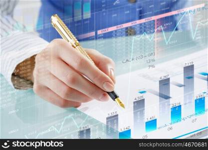 Financial analysis and forecast. Businessman hand writing with pen and digital business infographs